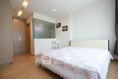 Spacious bedroom with modern decor and natural light