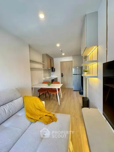 Modern living room with open kitchen layout and stylish decor
