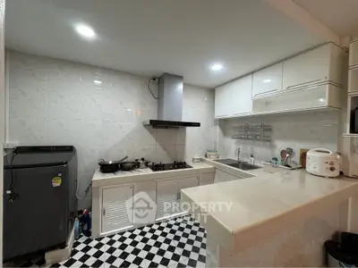 Modern kitchen with gas stove and sleek white cabinets