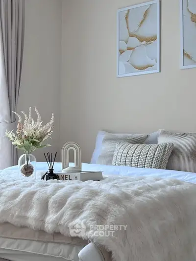 Elegant bedroom with plush bedding and stylish decor, perfect for relaxation and comfort.