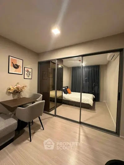 Modern apartment with stylish bedroom and dining area, featuring elegant decor and cozy ambiance.