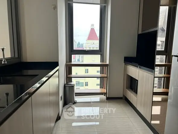 Modern kitchen with sleek cabinetry and large window view