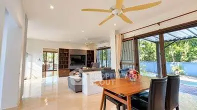 Spacious open-plan living room with dining area and garden view
