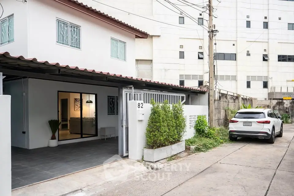 Modern townhouse with carport and sleek exterior design in urban setting