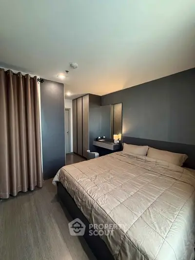 Modern bedroom with sleek design and cozy ambiance, featuring a comfortable bed and stylish decor.