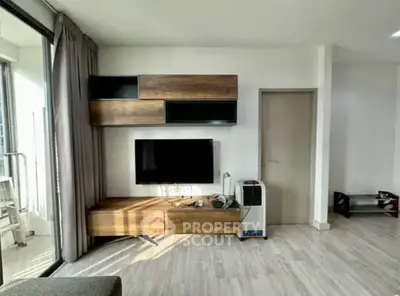 Modern living room with sleek wooden TV unit and balcony access
