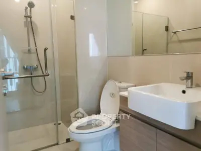 Modern bathroom with glass shower and sleek fixtures