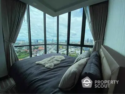 Luxurious bedroom with panoramic city view from floor-to-ceiling windows