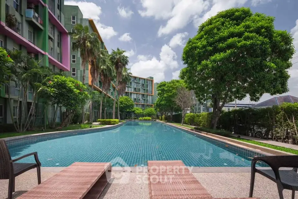 Luxurious apartment complex with stunning pool and lush greenery, perfect for relaxation and leisure.