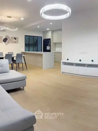 Modern open-plan living room with sleek furniture and stylish lighting