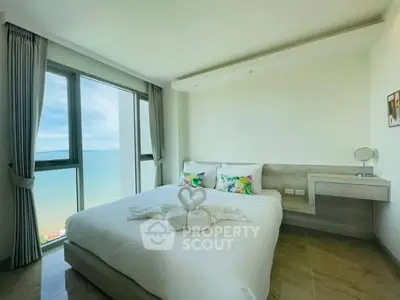 Stunning bedroom with ocean view, modern decor, and large windows in a luxury apartment.