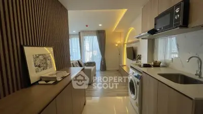 Modern open-layout kitchen with washing machine and cozy living area