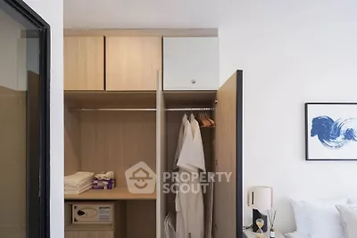 Modern bedroom with open wardrobe showcasing ample storage space and stylish decor.
