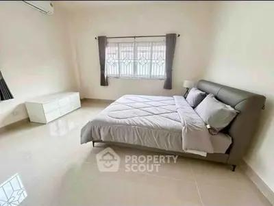 Spacious bedroom with modern decor and natural light