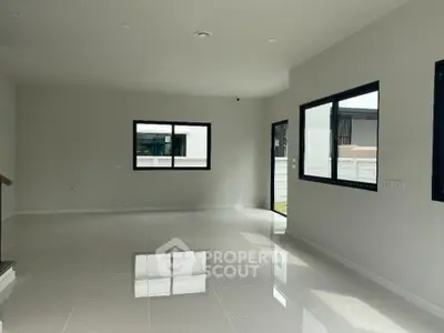 Spacious modern living room with large windows and glossy tiled floor