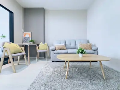 Modern living room with cozy sofa, stylish chairs, and elegant decor in a bright, inviting space.