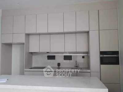 Modern kitchen with sleek cabinetry and built-in appliances