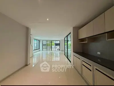Spacious modern living room with open layout and sleek kitchen design