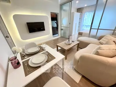 Modern living room with cozy seating and stylish dining area in open layout apartment.
