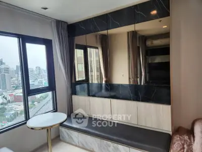 Modern apartment interior with city view, featuring marble accents and stylish seating area.