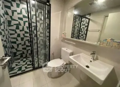 Modern bathroom with geometric shower design and sleek fixtures