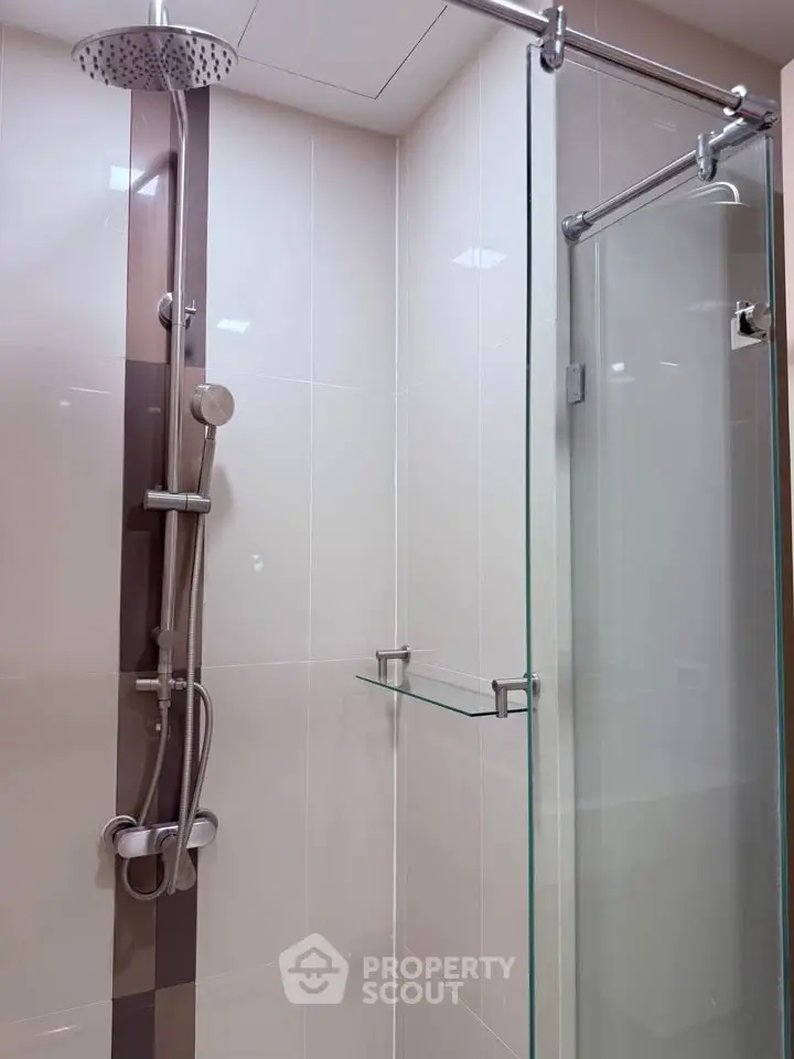 Modern bathroom with glass shower enclosure and sleek fixtures