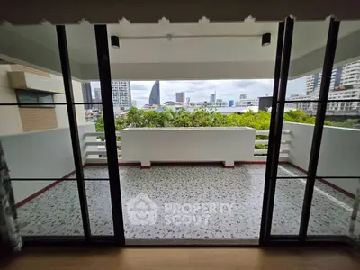 Spacious balcony with city view, perfect for relaxation and enjoying the skyline.