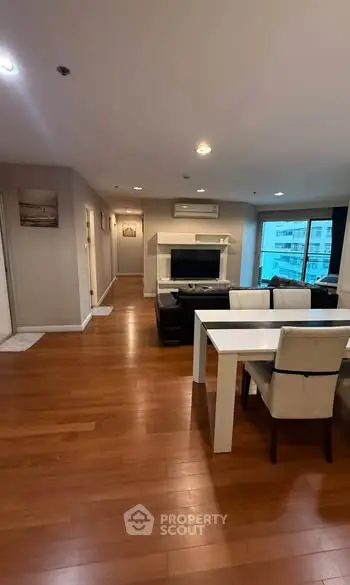 Spacious modern living room with wooden flooring and elegant dining area