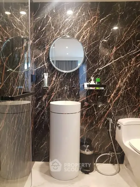 Luxurious modern bathroom with marble walls and sleek fixtures