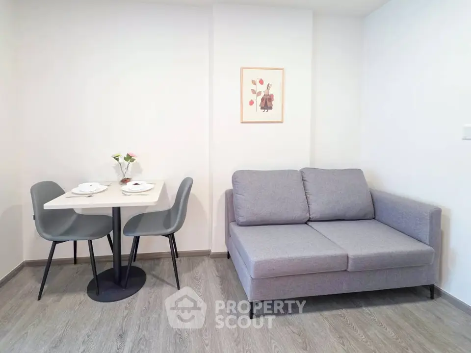 Modern living room with cozy gray sofa and dining area, perfect for urban living.