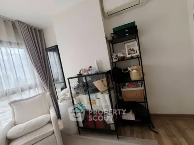 Modern living room with stylish shelving and air conditioning, featuring floor-to-ceiling windows and elegant decor.