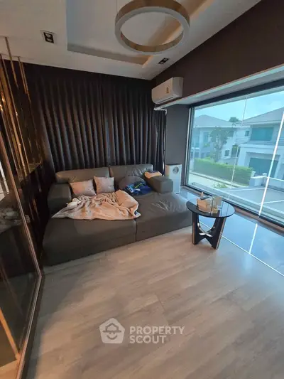 Modern living room with large window and stylish sofa in a contemporary home