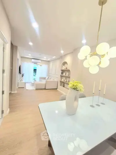 Elegant open-plan living room with modern decor and stylish lighting, perfect for contemporary living.