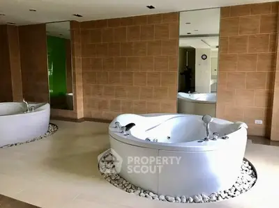 Luxurious spa-like bathroom with modern jacuzzi tub and elegant tile design.