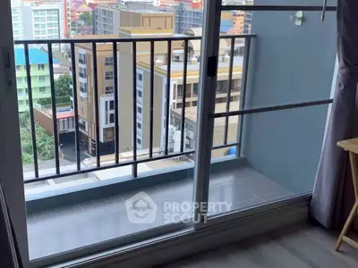 Modern apartment balcony with city view and sliding glass doors