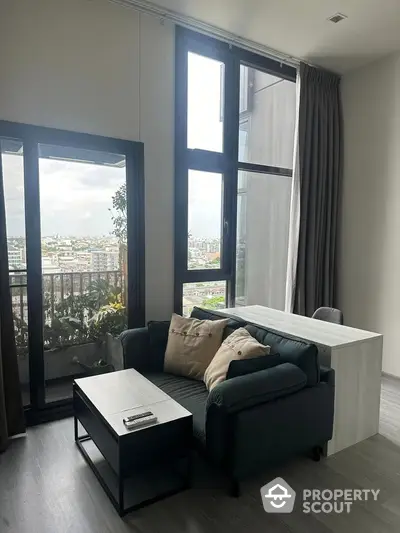 Modern living room with large windows and city view balcony