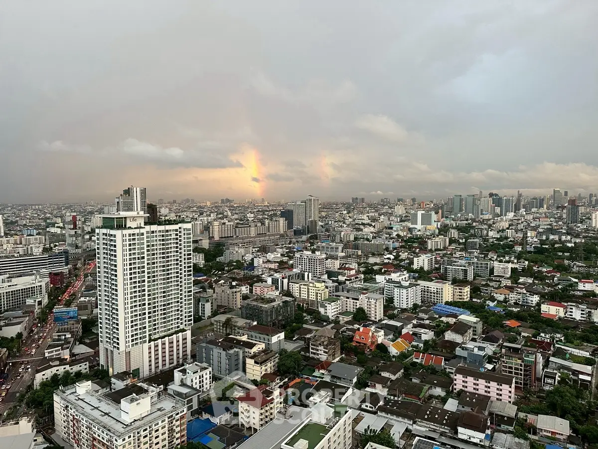 Stunning cityscape view from high-rise building showcasing urban skyline at sunset.