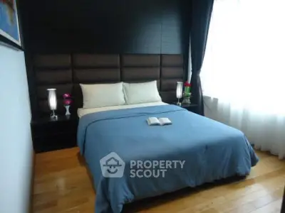 Cozy bedroom with modern decor and natural light, featuring a comfortable bed and elegant bedside lamps.