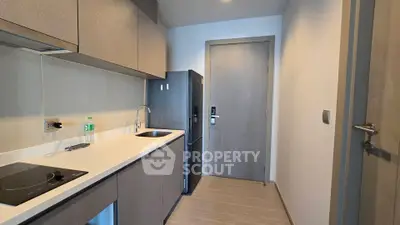 Modern kitchen with sleek cabinetry and integrated appliances in a contemporary apartment.
