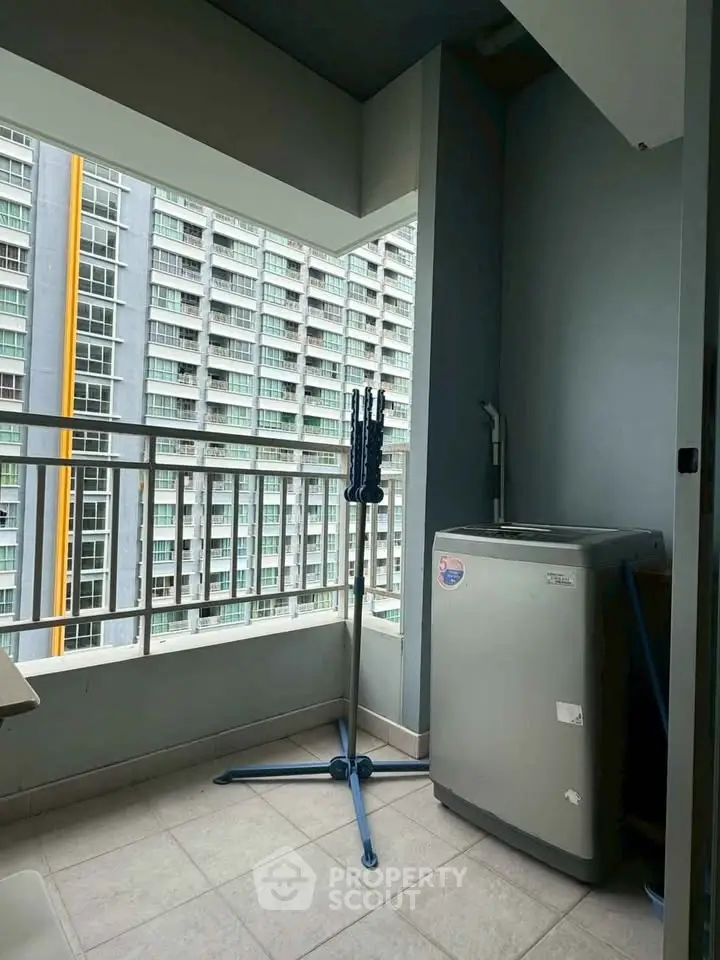 Modern apartment balcony with washing machine and city view