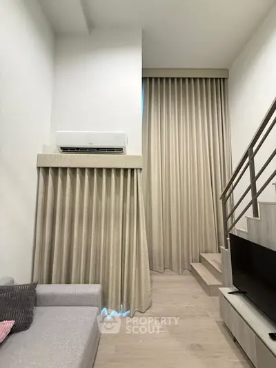 Modern living room with high ceilings and stylish staircase