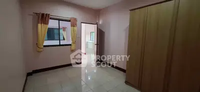 Spacious bedroom with wardrobe and window in cozy apartment