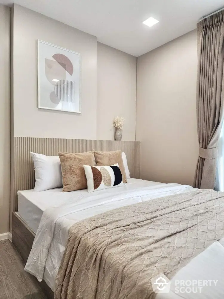 Elegant bedroom with modern decor and cozy bedding in a stylish apartment.