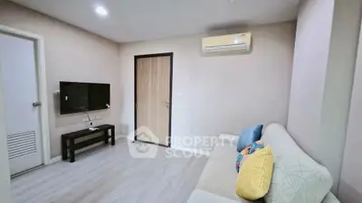 Modern living room with sleek design, featuring a wall-mounted TV and cozy sofa, perfect for relaxation.