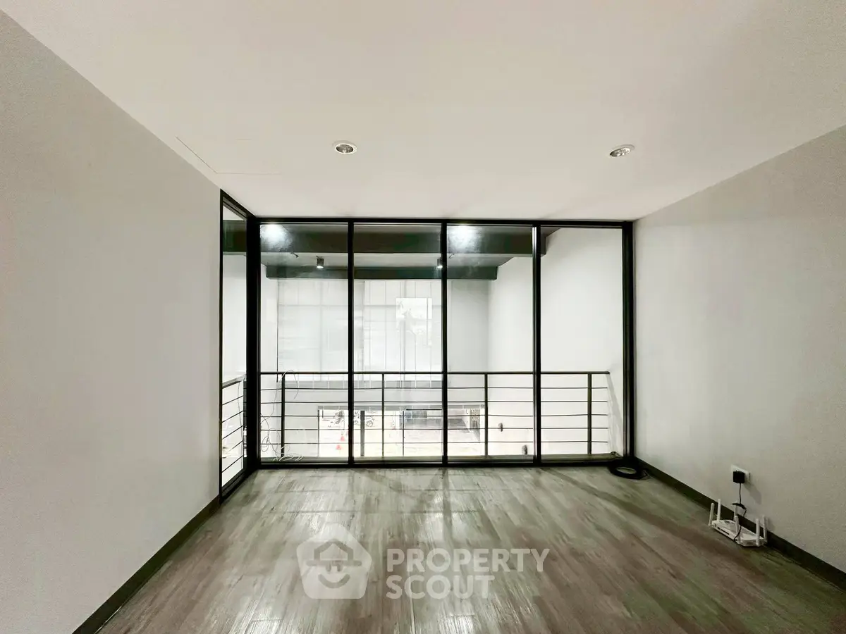 Spacious modern room with large windows and sleek flooring