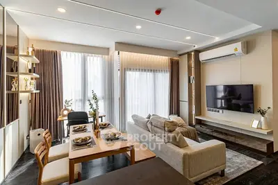 Modern living room with stylish decor, large windows, and cozy dining area in a contemporary apartment.