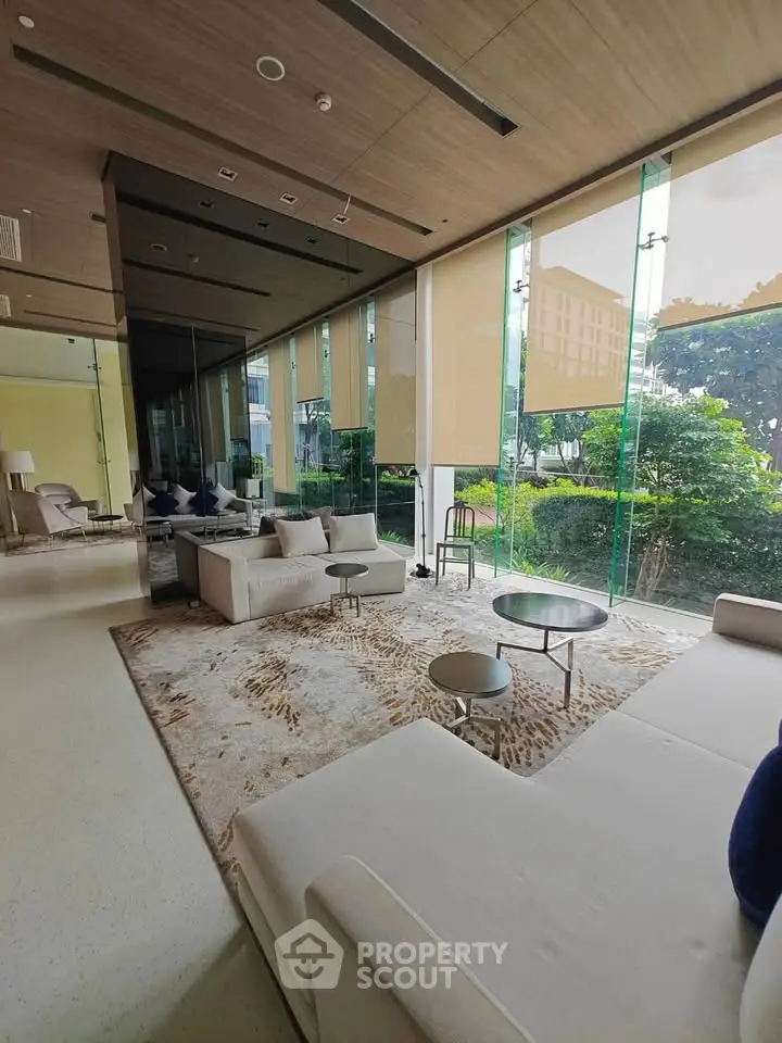 Luxurious modern living room with floor-to-ceiling windows and elegant furnishings.