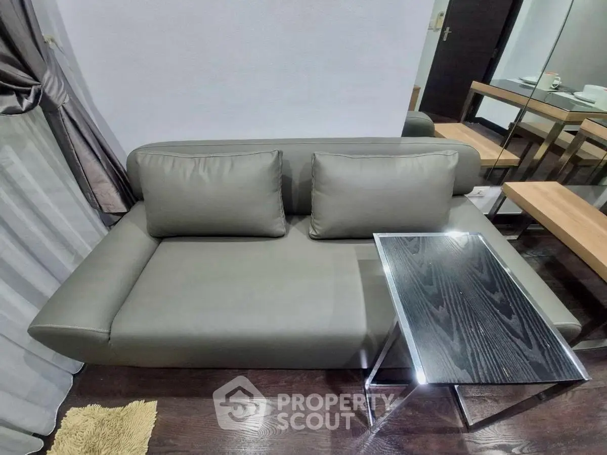 Modern living room with sleek gray sofa and stylish glass table