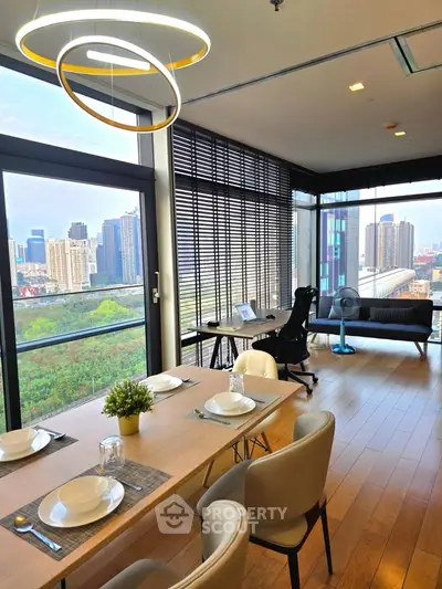 Modern living room with stunning city view, stylish dining area, and sleek office space in a high-rise apartment.