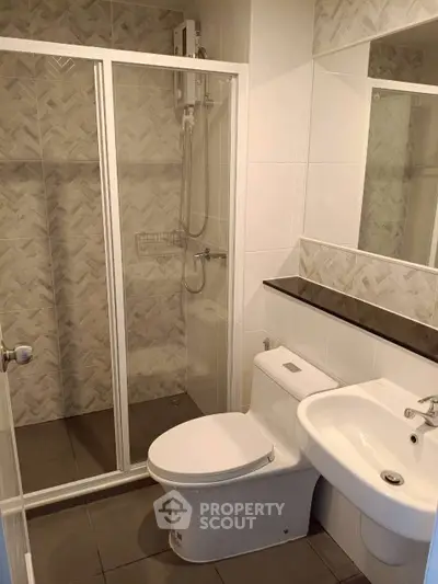 Modern bathroom with glass shower and sleek fixtures